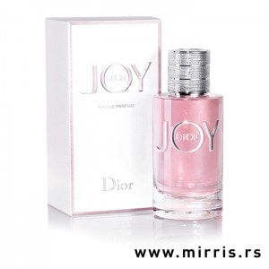 Roza flašica parfema Christian Dior Joy pored bele kutije